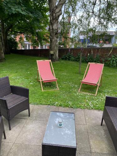 2 sillas y una mesa de centro en un patio en STABLE COTTAGE en Cheswardine