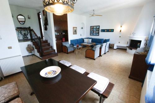 a living room with a dining table and a living room at Villa Paradiso in Neos Marmaras