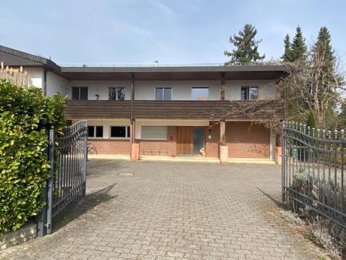 a large brick building with a gate in front of it at Apartments in Leafy Suburb in Kehrsatz