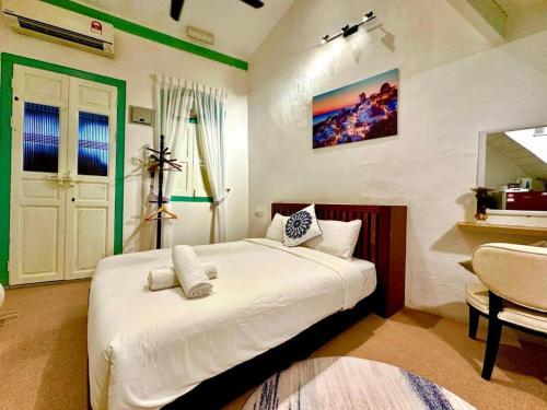 a bedroom with a large white bed in a room at Le Meilleur in George Town