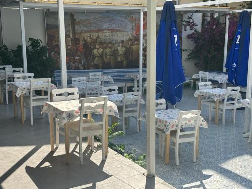 a group of tables and chairs in a restaurant at OTEL A in Çeşme