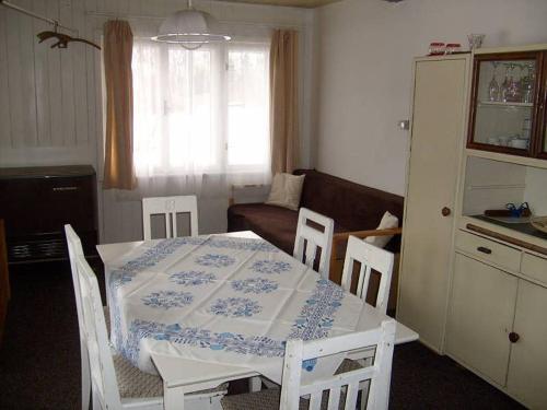 a kitchen and living room with a table and chairs at Chata Čeřovský Harrachov in Harrachov