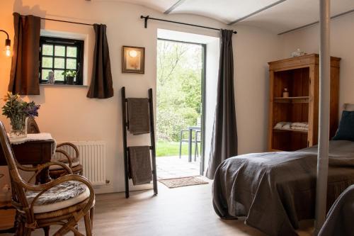 a bedroom with a bed and a door to a yard at Berits Bed and Breakfast in Haderslev