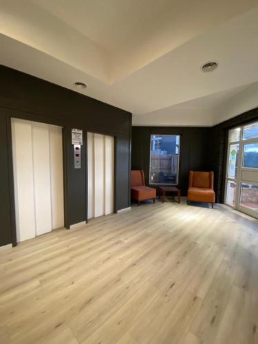 an empty room with two chairs and a wooden floor at Costa Carilo Apart de Mar By HS in Carilo