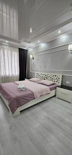 a bedroom with a large bed in a room at ЖК Арбат в самом центре города in Almaty