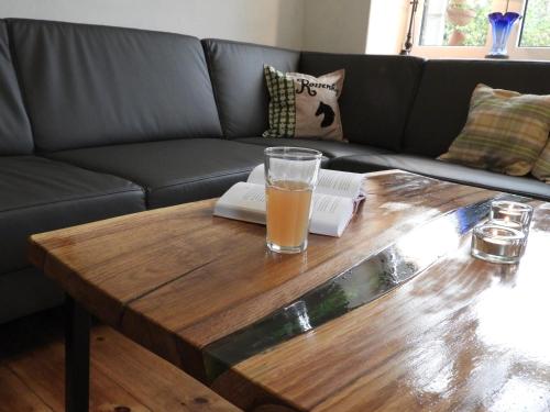 a coffee table with a glass of beer on it at Ferienwohnung Rossenhof in Weesby