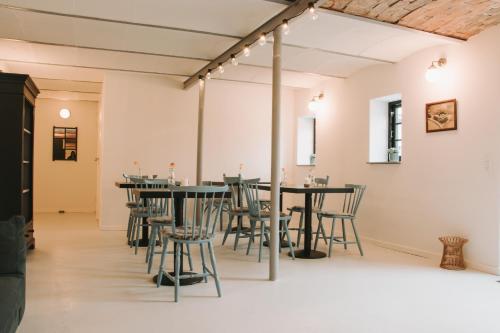 a group of tables and chairs in a room at Berits Bed and Breakfast in Haderslev
