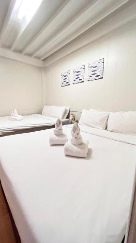 Postel nebo postele na pokoji v ubytování UDEE Cozy Hotel