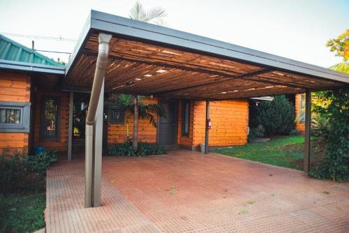 a building with a metal roof and a brick patio at Irová Apart Hotel in Posadas