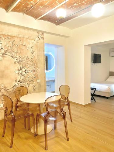 a dining room with a table and chairs and a bed at Hotel Tirreno in Marina di Massa