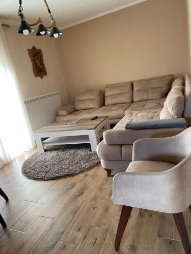 a living room with a couch and a table at Vikendica Una in Kolašin