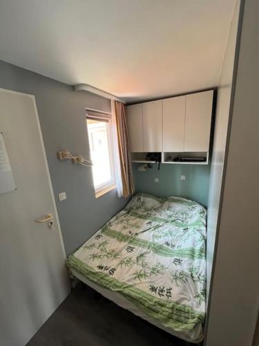 une petite chambre avec un lit et une fenêtre dans l'établissement Studio climatisé 4 personnes, à Saint-Raphaël