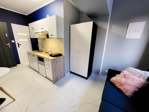 a small kitchen with a blue and white kitchen at Mini Apartamenty Poznań in Poznań