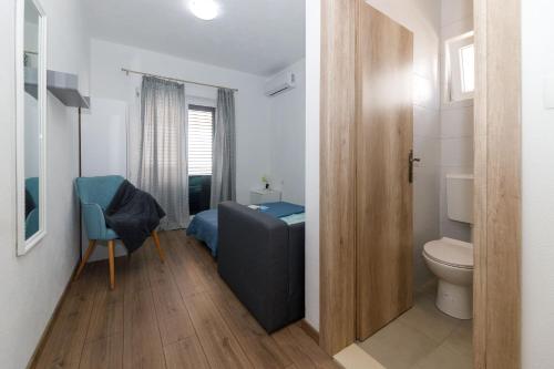 a bathroom with a bed and a toilet in a room at Blue home in Makarska