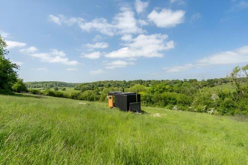a black and orange object in the middle of a field at Secluded Offgrid Cabin w/ Sunset View & Fireplace in Canterbury