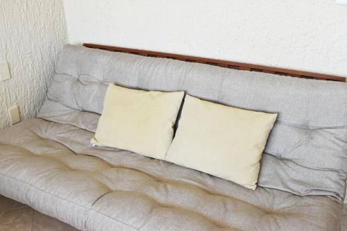 two pillows sitting on top of a couch at Habitación 1704 in Cancún