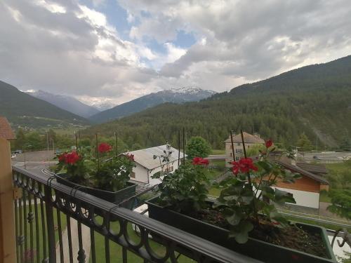 a balcony with a view of a city and mountains at Via Cancano Valdidentro-Bormio in Premadio