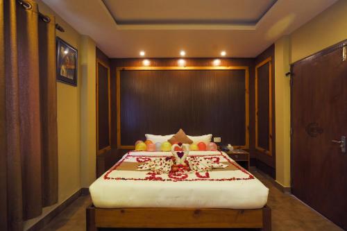 a bedroom with a bed with fruit on it at Paradise Boutique Hotel in Pokhara