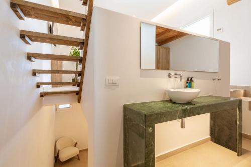 a bathroom with a sink and a staircase at Aya Sofia Suites in Mikonos