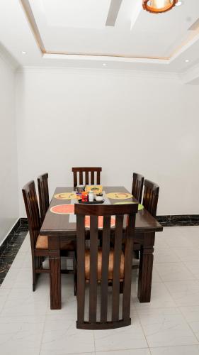 ナイバシャにあるAdvent Homes on Moi South lake road, Villa View Estateの部屋の中の木製のテーブルと椅子