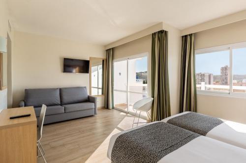 Un ou plusieurs lits dans un hébergement de l'établissement Hotel Samos