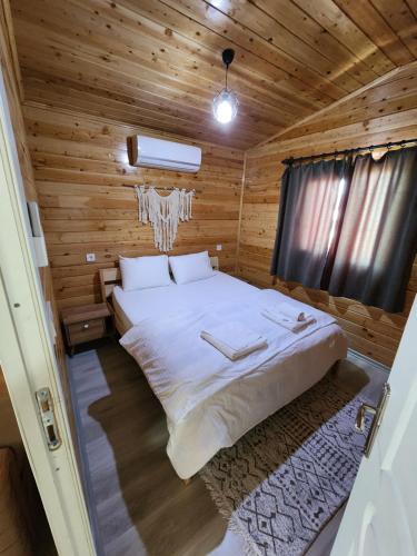 a bedroom with a bed in a wooden cabin at Sea garden apart in Demre