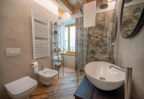 a bathroom with a sink and a toilet and a shower at La Fontanella - Holiday Apartments in Arco