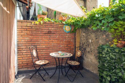 a small table and chairs on a patio at A Ugghia- Dependance in Fiumefreddo di Sicilia