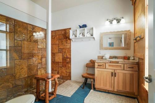 a bathroom with a shower and a sink at Stairway to Heaven Hot Tub Beach Retreat in Flagler Beach