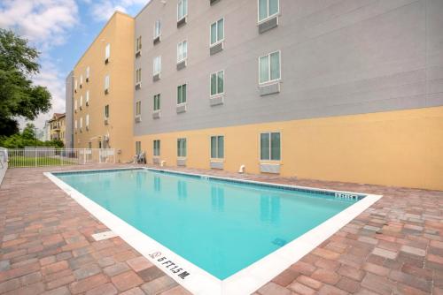 a swimming pool in front of a building at Comfort Inn & Suites Destin near Henderson Beach in Destin