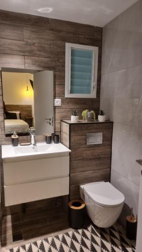 a bathroom with a sink and a toilet and a mirror at tree house eilat in Eilat