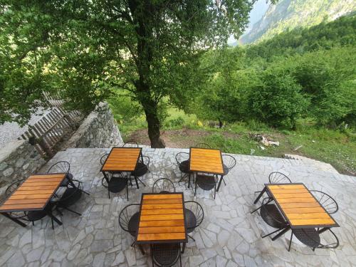 a group of tables and chairs on a patio at Villa Davisol in Theth