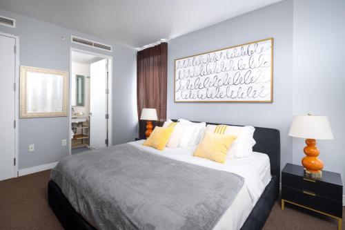 a bedroom with a large bed with yellow pillows at Luxurious 1BD Apartment Steps from Times Square in New York
