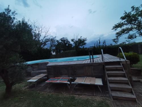 una piscina con una casa y algunas sillas en FONDO MARSIGLIA 110 en Lido di Spina