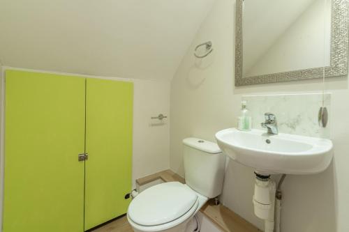a bathroom with a white toilet and a sink at Southview Annexe in Sculthorpe