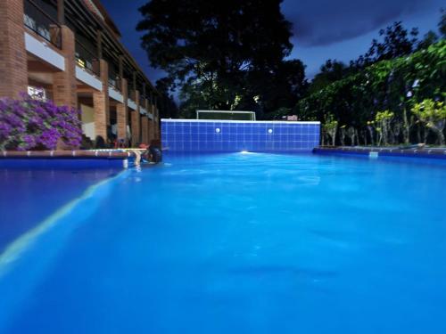 a large swimming pool in front of a building at Casa hotel la Cachamera in Granada