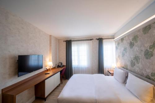 Postel nebo postele na pokoji v ubytování MELL City Suites Hotel