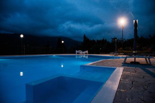 een groot zwembad 's nachts met een licht bij Quattroemme Soc Agricola in Sinagra