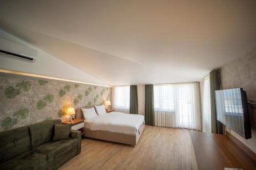 Postel nebo postele na pokoji v ubytování MELL City Suites Hotel