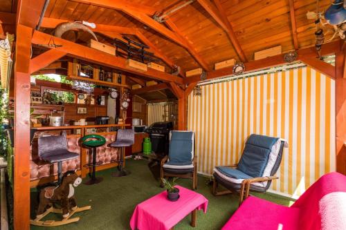 a living room with chairs and a dog in it at Apartment Pool&Garden in Rijeka