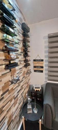 a living room with a wall of wine bottles at Lax Uno 2 bedroom home with Parking, Wi-Fi, NetFlix and Airconditioned Rooms and Shower Heater in Antipolo