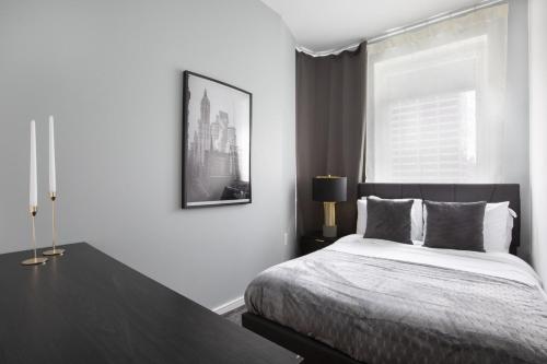 a bedroom with a bed and a large window at Stylish 2BD with Washer and Dryer near Times Square in New York