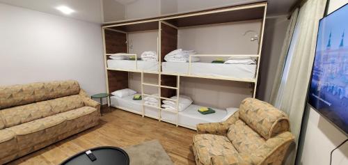 a living room with a couch and two chairs at La Casa EmilioAngi in Yerevan