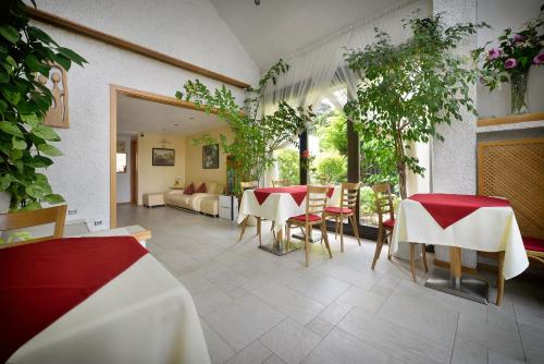 a restaurant with a table and chairs and a couch at A. V. Pension Praha in Prague