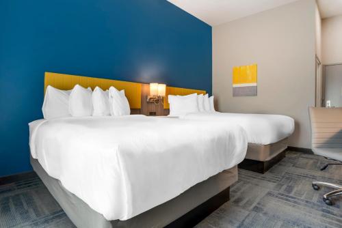 two large white beds in a hotel room at Comfort Inn & Suites Destin near Henderson Beach in Destin