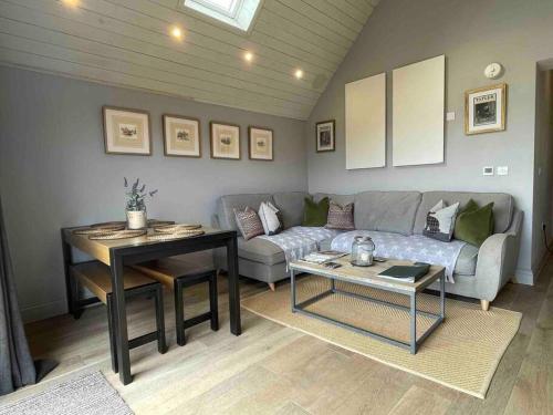 a living room with a couch and a table at The Old Stables in Salisbury