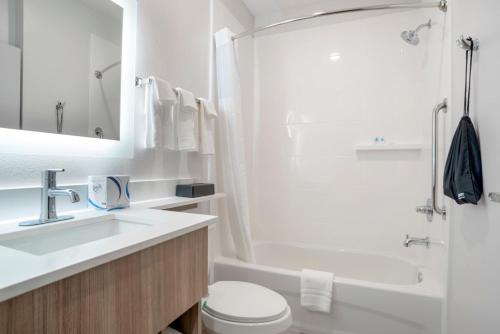 a bathroom with a sink and a toilet and a tub at Comfort Inn & Suites Destin near Henderson Beach in Destin