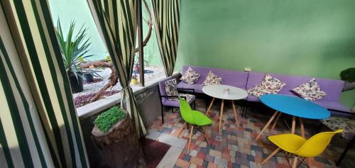 a living room with a purple couch and green chairs at La Casa EmilioAngi in Yerevan