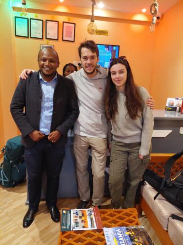 a group of three people posing for a picture at Kiteme Comfort Lodge in Arusha