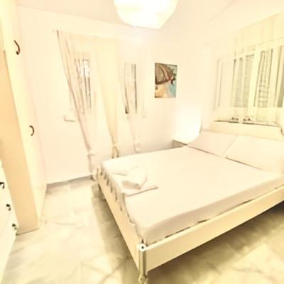 幾內塔的住宿－Nasia’s house，窗户客房内的一张白色床
